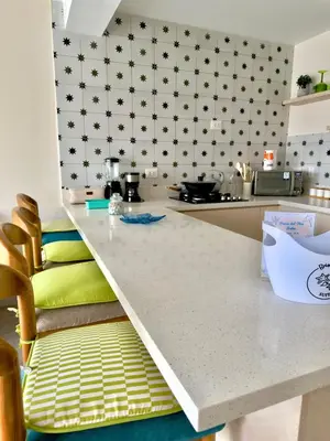 a kitchen with a white counter and a counter top at Modern apartment a short walk from the boulevard and beach in Punta Hermosa