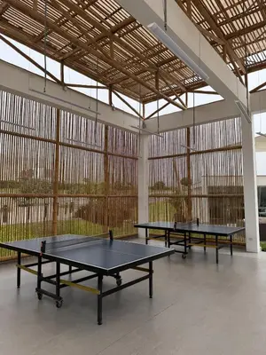 three ping pong tables in a large room with windows at Casa de Playa de Estreno in San Antonio