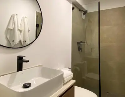 a bathroom with a sink and a shower and a mirror at Enchanting Loft with Balcony in Barranco in Lima