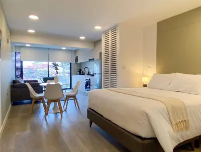 a bedroom with a large bed and a dining room at Enchanting Loft with Balcony in Barranco in Lima