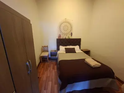 a bedroom with a large bed in a room at Acogedor Departamento Vitoque in Cusco
