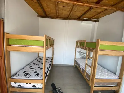 a room with two bunk beds in a room at Casa de Playa - Mara House in Huacho
