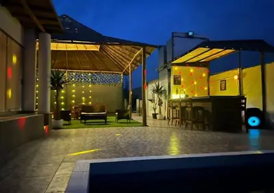 an outdoor patio with a table and chairs and lights at Casa de Playa - Mara House in Huacho