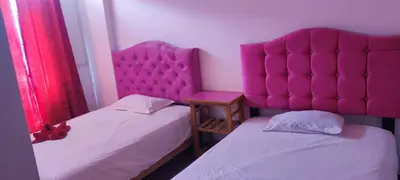 two beds with pink headboards in a room at HS OASIS pro lima in Lima