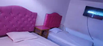 a small bedroom with a pink headboard and a bed at HS OASIS pro lima in Lima
