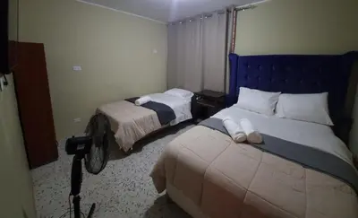 a bedroom with two beds in a room at Departamento en Ica super céntrico en Urb San Miguel in Ica