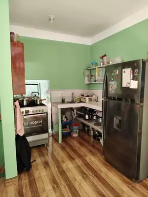 a kitchen with a refrigerator and a stove at Posada del Carmen in Quillabamba