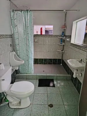 a bathroom with a shower and a toilet and a sink at Posada del Carmen in Quillabamba