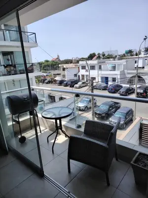 a balcony with a table and chairs and a view of a city at San bartolo 2 in San Bartolo