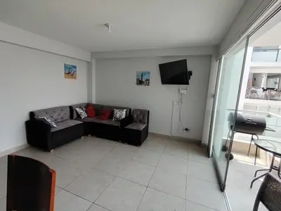 a living room with a couch and a tv at San bartolo 2 in San Bartolo