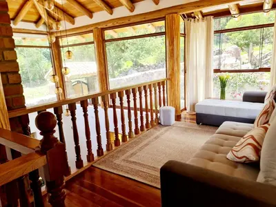 a living room with a couch and some windows at Beautiful house in the Sacred Valley, Arin Falls in Calca