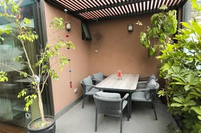 a patio with a wooden table and chairs at Diseño, Luz Natural y Jardín Privado en Loft in Lima