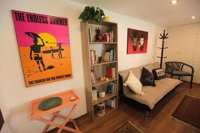 a living room with a couch and a book shelf at Diseño, Luz Natural y Jardín Privado en Loft in Lima