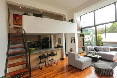 a large living room with a staircase and a living room at Diseño, Luz Natural y Jardín Privado en Loft in Lima