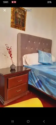 a bedroom with a bed and a dresser with a vase on it at Habitación en Barranco in Lima