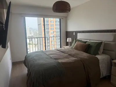 a bedroom with a large bed and a large window at Miraflores Premium in Lima