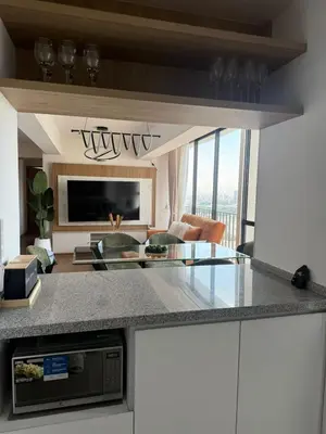 a kitchen with a counter top and a living room at Miraflores Premium in Lima
