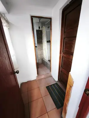 a hallway with a door and a tile floor at Mayu House Inn a minutos del centro histórico in Cusco