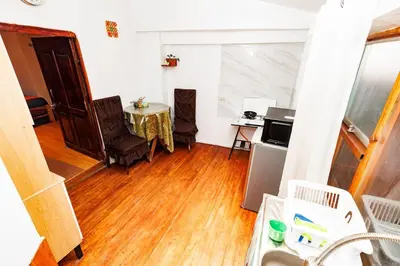 a kitchen with a table and chairs in a room at Mayu House Inn a minutos del centro histórico in Cusco