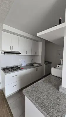 a white kitchen with a sink and a stove at Exclusive apartment in San Bartolo in San Bartolo