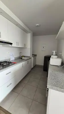 a kitchen with white cabinets and a counter top at Exclusive apartment in San Bartolo in San Bartolo