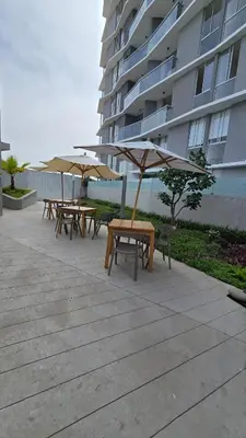 a group of tables with umbrellas in front of a building at Exclusive apartment in San Bartolo in San Bartolo