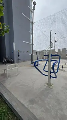 a blue hose in a parking lot next to a fence at Exclusive apartment in San Bartolo in San Bartolo