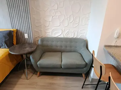 a couch in a room with a bed and a table at JAVIER PRADO ESTE 1501 LOFT- FRENTE a SAN BORJA in Lima