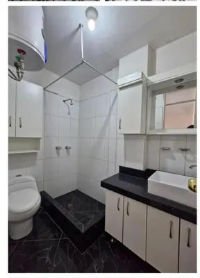 a white bathroom with a toilet and a sink at Modern Apartament Pool & Jacuzzi 1 room in Lima