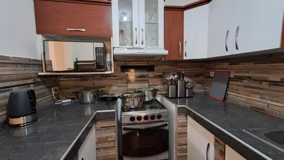 a kitchen with a stove and a microwave at Modern Apartament Pool & Jacuzzi 1 room in Lima