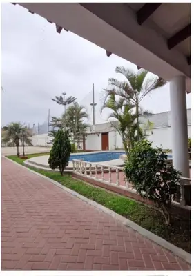 a brick walkway next to a building with a pool at Modern Apartament Pool & Jacuzzi 1 room in Lima