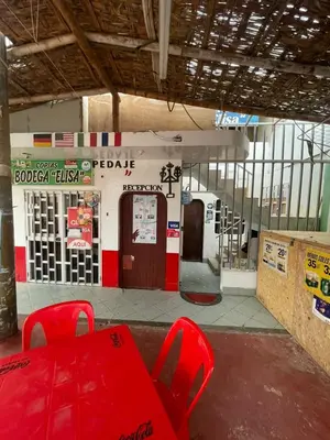 a gas station with red chairs in front of it at HOSPEDAJE VISTA DEL SOl PARACAS in Paracas
