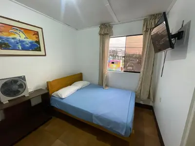 a small bedroom with a bed and a window at HOSPEDAJE VISTA DEL SOl PARACAS in Paracas