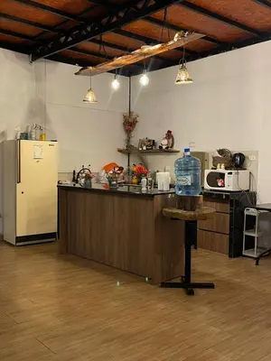 a kitchen with a counter and a refrigerator at Casa La Morada Ecolodge in Ayacucho