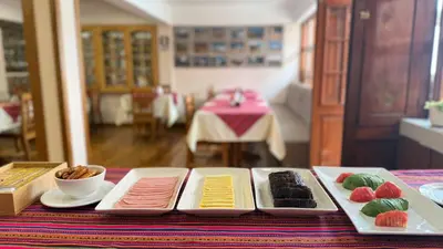 a table with three plates of different types of food at Casa Elena in Cusco