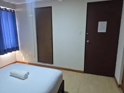a bedroom with a white bed and a mirror at Hotel Naciones Unidas in Lima