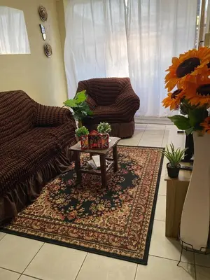 a living room with a couch and a coffee table at Central 3 minutes from Plaza de Armas by car in Quillabamba