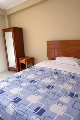 a bedroom with a blue and white quilt on a bed at Central 3 minutes from Plaza de Armas by car in Quillabamba