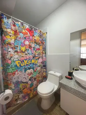 a bathroom with a toilet and a shower curtain at Anime-Style Studio Decor in Lima