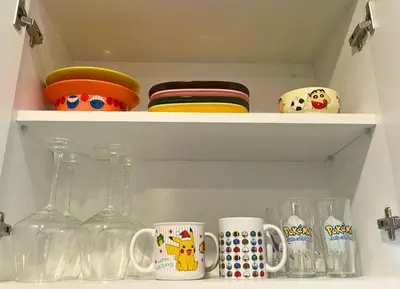 a cupboard with dishes and mugs on it at Anime-Style Studio Decor in Lima