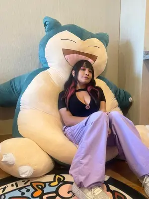 a girl is laying in a bed shaped like a fox at Anime-Style Studio Decor in Lima
