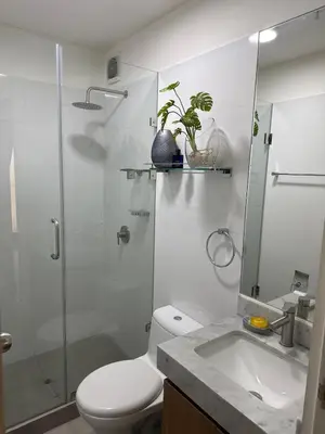 a bathroom with a toilet and a shower and a sink at Salaverry Luxury Apartment in Lima