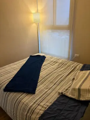a bed in a room with a pillow on it at Salaverry Luxury Apartment in Lima