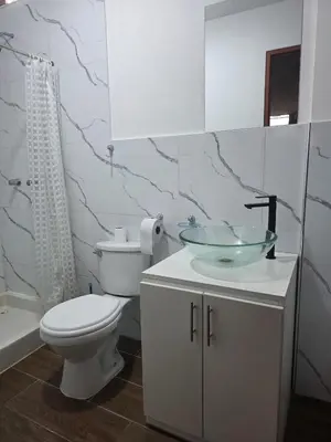 a bathroom with a sink and a toilet and a shower at room rent in Lima