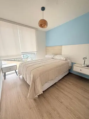 a bedroom with a large bed and a window at Departamento con vista al Mar in San Bartolo