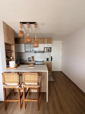 a kitchen with a table and chairs in a room at Departamento con vista al Mar in San Bartolo