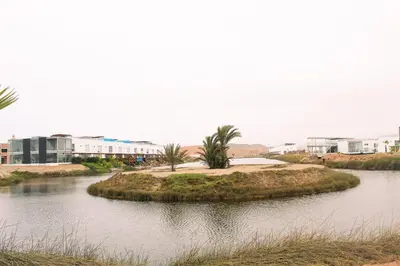 an island in the middle of a body of water at Increible casa de playa con vista al lago in San Vicente de Cañete