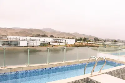 a swimming pool with a view of a body of water at Increible casa de playa con vista al lago in San Vicente de Cañete