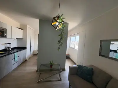 a living room with a couch and a table at Departamento en barranco in Lima