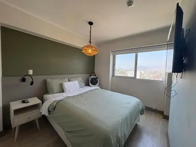 a bedroom with a large bed and a window at Departamento en barranco in Lima